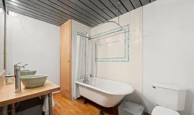 a bathroom with a tub and a toilet and a sink at Sun-Filled Luxury Historic 2 Bedrooms apto in New York