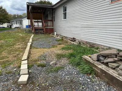 a yard next to a house with a building at Comfortable 3BR, 2BA Perfect for Families! in Mechanicsburg
