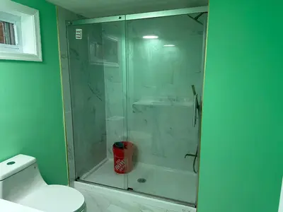 a glass shower in a bathroom with a toilet at Comfortable 3BR, 2BA Perfect for Families! in Mechanicsburg