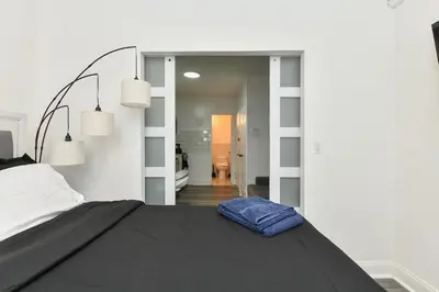 a bedroom with a bed with a blue pillow on it at Cozy 1BR in Central Manhattan W Private Terrace in New York