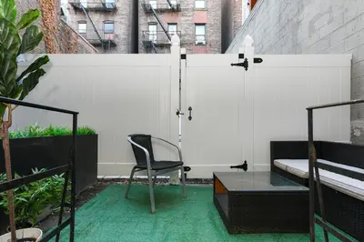 a chair and a table on a balcony at Cozy 1BR in Central Manhattan W Private Terrace in New York