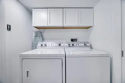 a white kitchen with a stove and white cabinets at Poconos Lakefront Retreat | * Hot Tub * Arcades * in Long Pond