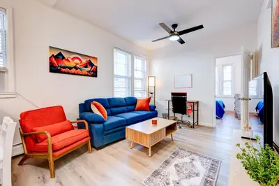 a living room with a blue couch and a table at The Hamilton Elm in Teaneck