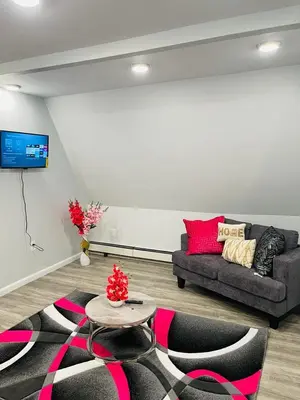 a living room with a couch and a table at Xceptional homes in East Orange