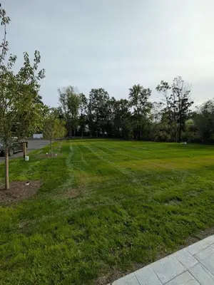 a large grass field with trees in the background at Carriage House Apartment Close to Legoland NY in Goshen