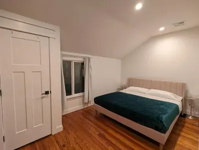 a white bedroom with a bed and a window at Carriage House Apartment Close to Legoland NY in Goshen