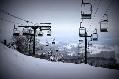 a ski lift going up a snow covered mountain at Hay Loft in Historic Barn - 4 Minutes to Legoland in Goshen