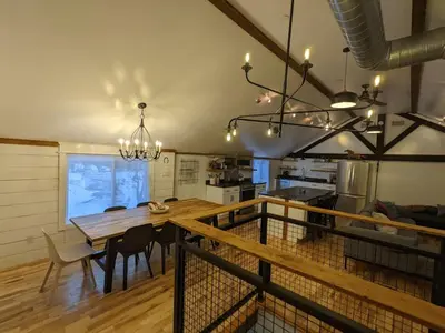 a dining room and kitchen with a table and chairs at Hay Loft in Historic Barn - 4 Minutes to Legoland in Goshen