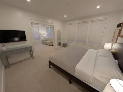 a bedroom with a large bed and a flat screen tv at Parkway House Goshen Bed And Breakfast Suite 3 in Goshen