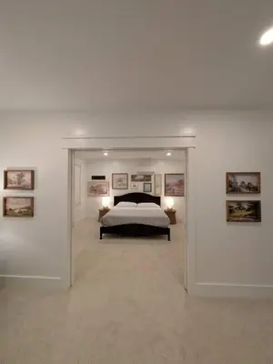 a bedroom with a bed and some pictures on the wall at Parkway House Goshen Bed And Breakfast Suite 3 in Goshen