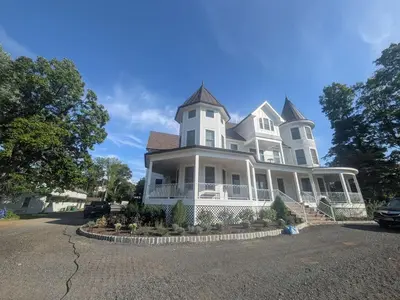 a large white house with a turret at Parkway House Goshen Bed And Breakfast Suite 3 in Goshen