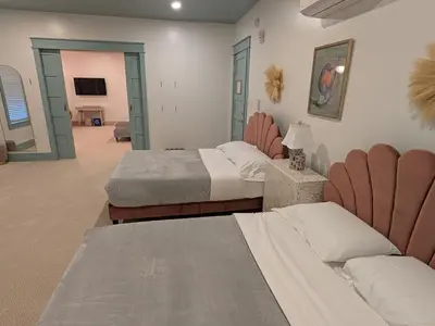 a hotel room with two beds and a couch at Parkway House Goshen Bed And Breakfast Suite 1 in Goshen