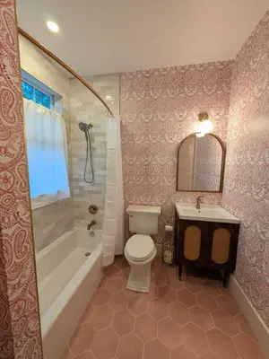 a bathroom with a toilet and a tub and a sink at Parkway House Goshen Bed And Breakfast Suite 1 in Goshen