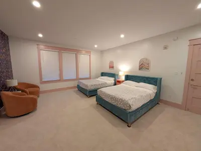 a bedroom with two beds and a chair at Parkway House Goshen Bed And Breakfast Suite 4 in Goshen