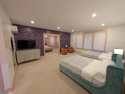 a bedroom with two beds and a flat screen tv at Parkway House Goshen Bed And Breakfast Suite 4 in Goshen