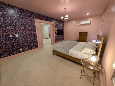 a bedroom with a bed and a tv on a wall at Parkway House Goshen Bed And Breakfast Suite 4 in Goshen