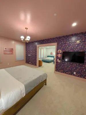 a bedroom with a bed and a flat screen tv at Parkway House Goshen Bed And Breakfast Suite 4 in Goshen