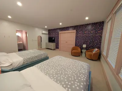 a large bedroom with two beds and a door at Parkway House Goshen Bed And Breakfast Suite 4 in Goshen