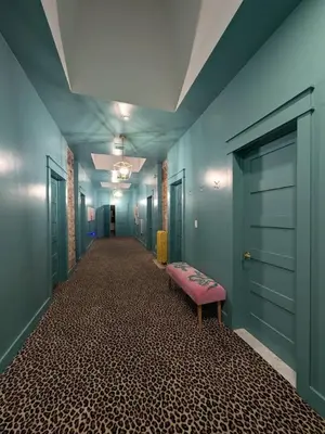 a long corridor with a pink bench in a room at Parkway House Goshen Bed And Breakfast Suite 5 in Goshen