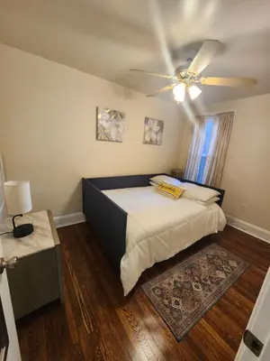 a bedroom with a bed and a ceiling fan at Lansdowne Gem in Lansdowne