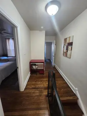 a hallway with a room with a bed and a table at Lansdowne Gem in Lansdowne