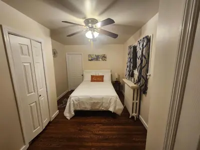 a bedroom with a bed and a ceiling fan at Lansdowne Gem in Lansdowne