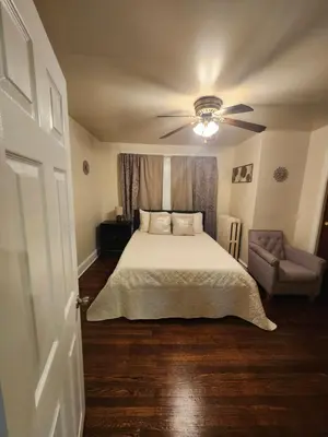a bedroom with a bed and a ceiling fan at Lansdowne Gem in Lansdowne