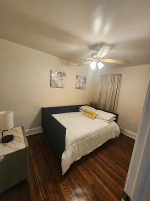 a bedroom with a bed and a ceiling fan at Lansdowne Gem in Lansdowne