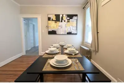a dining room with a table with plates on it at Cozy 3 Bedrooms Spacious Comfort in Orange