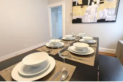 a dining room table with white plates and wine glasses at Cozy 3 Bedrooms Spacious Comfort in Orange