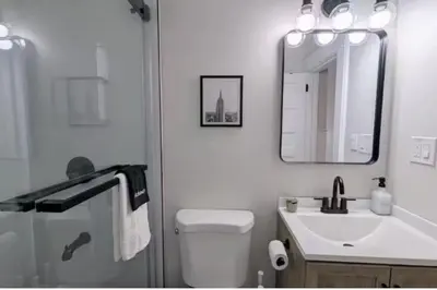 a bathroom with a toilet and a sink and a mirror at Cozy 3 Bedrooms Spacious Comfort in Orange