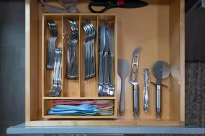 a wooden cabinet with utensils in it at The Harper Loft in Hoboken