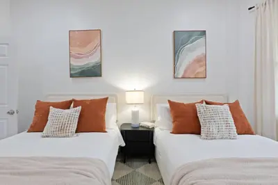 two beds sitting next to each other in a bedroom at The Harper Loft in Hoboken