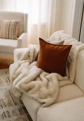 a blanket sitting on a couch with a pillow at The Caleb Loft in Hoboken