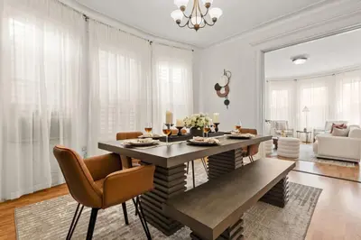 a living room with a dining table and chairs at The Caleb Loft in Hoboken