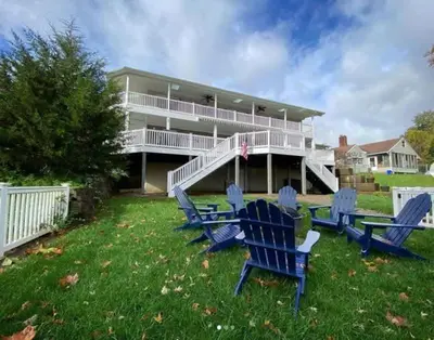 a group of blue chairs in front of a house at The Riverfront in Easton