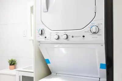 a white dishwasher in a kitchen with a mirror at 26-1C Gramercy Large 1BR WD in New York