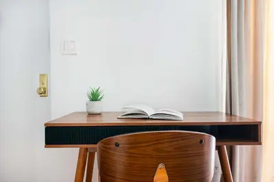 a wooden desk with an open book and a book at 26-1C Gramercy Large 1BR WD in New York