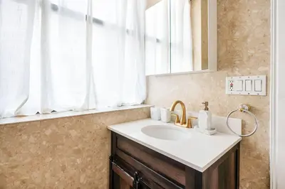 a bathroom with a sink and a mirror and a window at 26A-2 Spacious brand new Fully Furnished 2-Bedroom in Prime Murray Hill Move-In Ready in New York