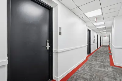a corridor of an office with a black door at Cozy modern studio in prime area in Philadelphia