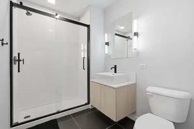 a bathroom with a shower and a toilet and a sink at Cozy modern studio in prime area in Philadelphia