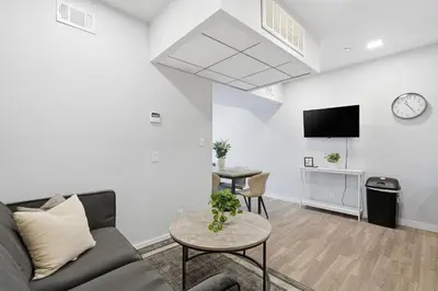 a living room with a couch and a table at Cozy modern studio in prime area in Philadelphia