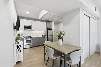 a kitchen and dining room with a table and chairs at Cozy modern studio in prime area in Philadelphia