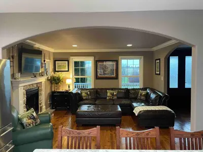 a living room with a couch and a fireplace at Charming Farmhouse In Quarryville,PA in Quarryville