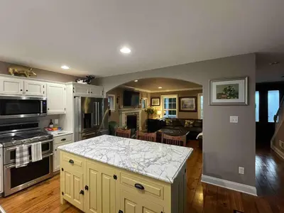a kitchen with a counter top and a living room at Charming Farmhouse In Quarryville,PA in Quarryville