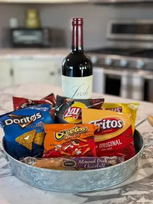 a bowl of chips and a bottle of wine at Charming Farmhouse In Quarryville,PA in Quarryville