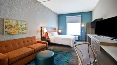 a hotel room with a bed and a couch at Home2 Suites by Hilton in Mechanicsburg
