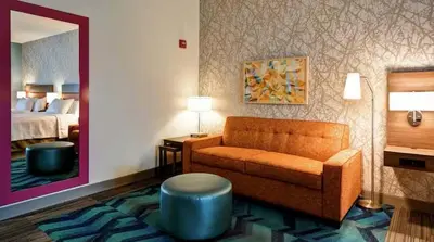 a hotel room with a couch and a bed at Home2 Suites by Hilton in Mechanicsburg