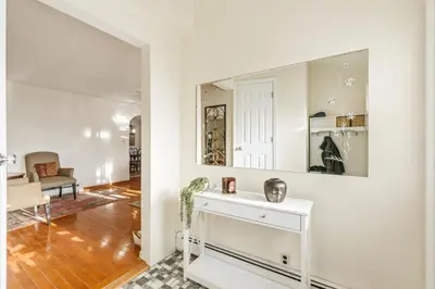 a living room with a mirror on the wall at Family Retreat Near NYC w/ Parking & Views in Hackensack