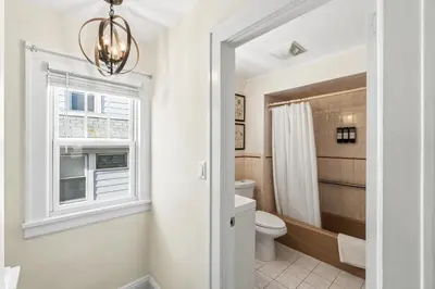a bathroom with a toilet and a window at Family Retreat Near NYC w/ Parking & Views in Hackensack